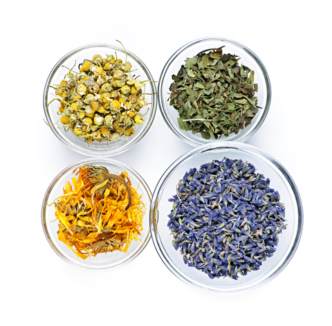 Four bowls of dried tea botanicals, seen from above